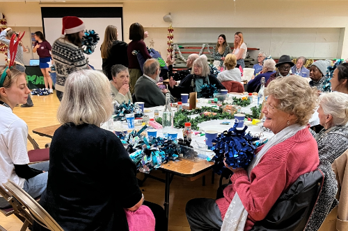  A winter tea party arranged by the University's Volunteering Team With a few old people enjoying the event. 